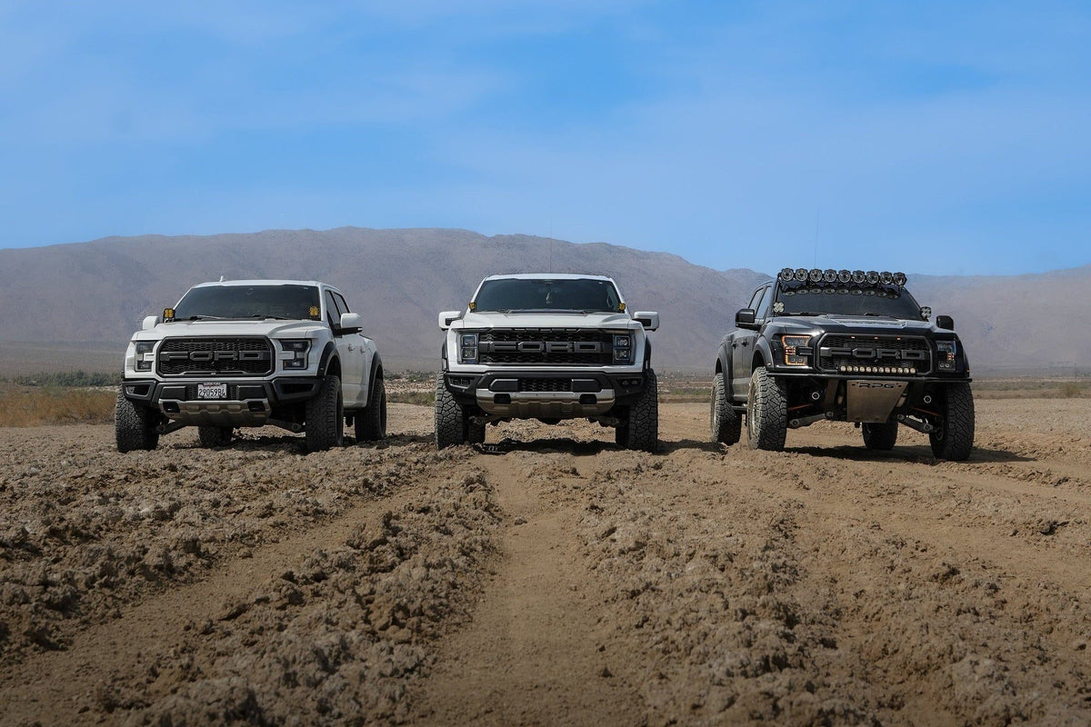 Three Ford Raptors from CA Supply Co. in the desert